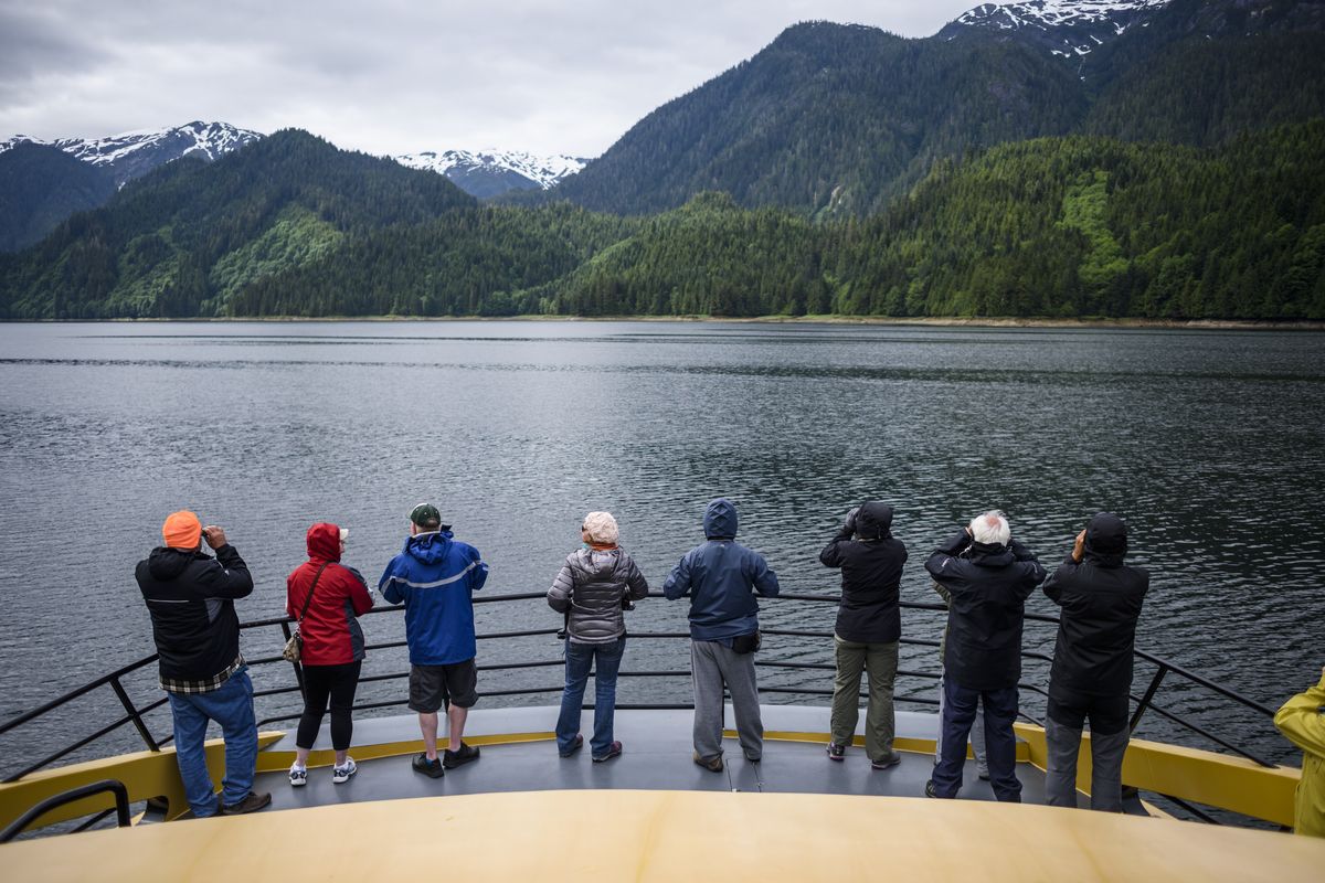 Group on ferry touring, searching for bears in the Khutzeymateen Grizzly Bear Sanctuary, Northern British Columbia